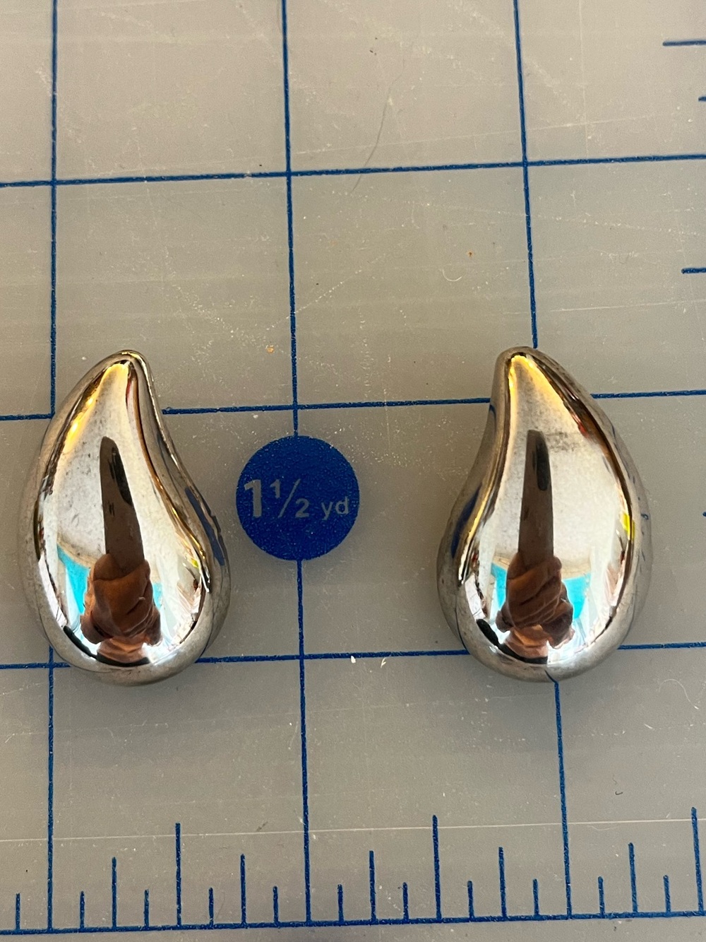 Large silver coloured teardrop earrings